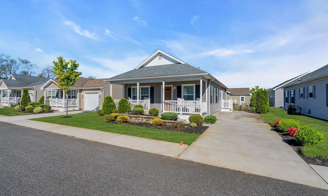 A modern home at Osprey Cove with a covered front porch and landscaped garden